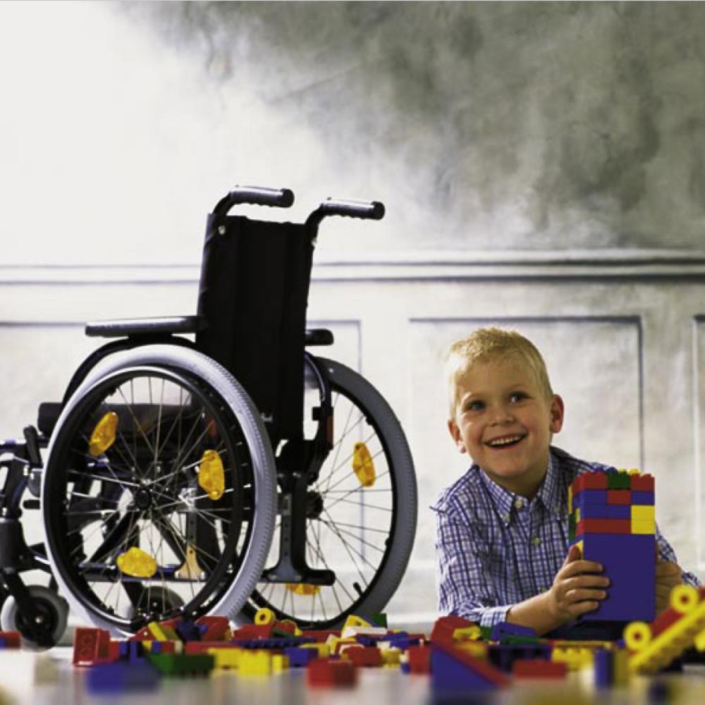 Ottobock Start M6 Junior - Child Playing next to Mobility Scooter.